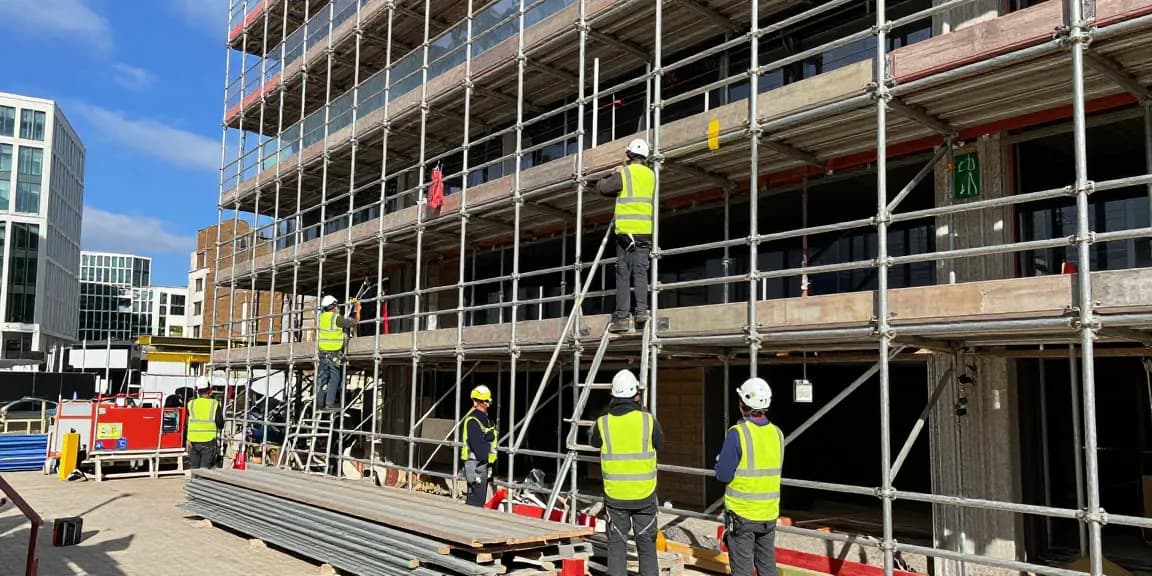 Commercial scaffolding installation showcasing skilled technicians at a construction site in London.